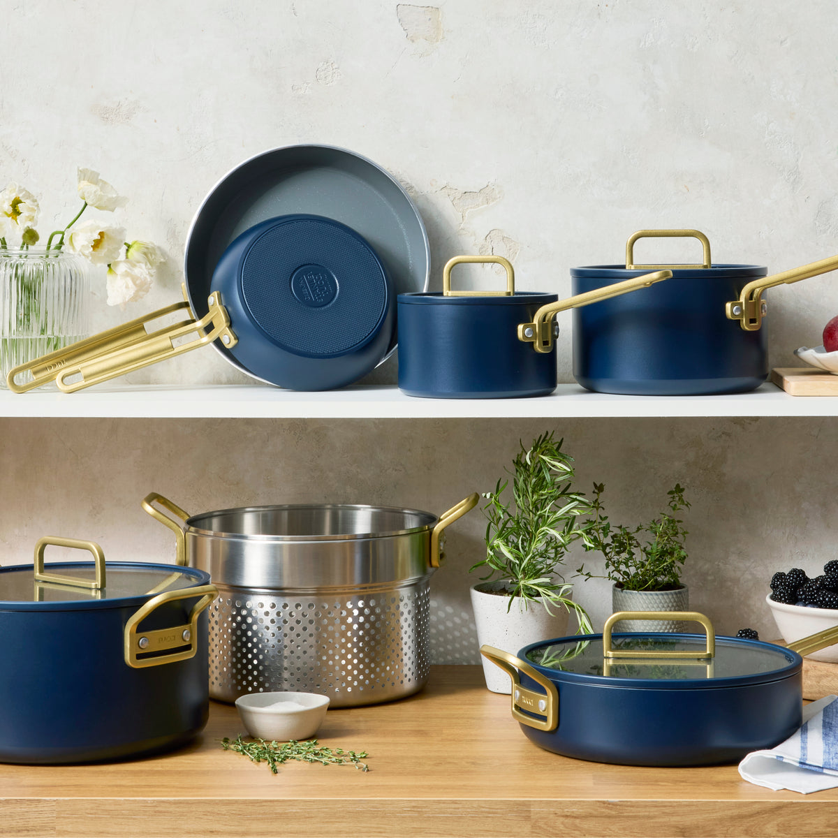 Blue ceramic nonstick 2-quart saucepan with lid on a kitchen counter.