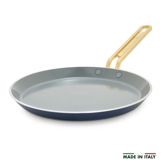 Blue crepe pan with a gold handle on a white background